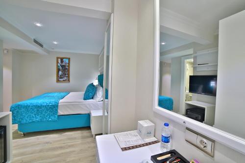 a room with a bed and a mirror at Glamour Hotel Istanbul Sirkeci in Istanbul