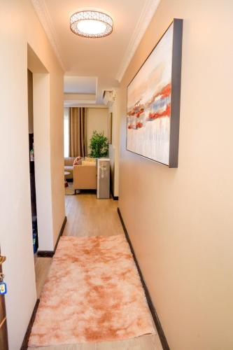 a hallway with a painting hanging on a wall at Elegant 3 Bedroom Apartment - 1255 Palm Ridge in Vipingo