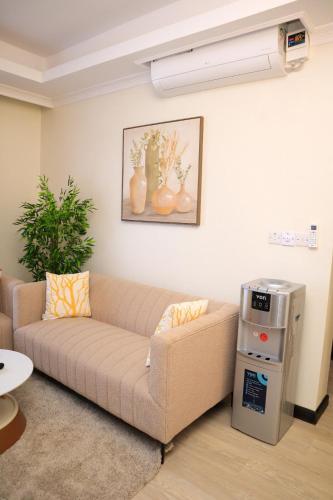 a living room with a couch in a room at Elegant 3 Bedroom Apartment - 1255 Palm Ridge in Vipingo