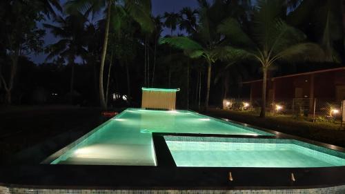 an empty swimming pool at night at West Coast Gokarna in Gokarna