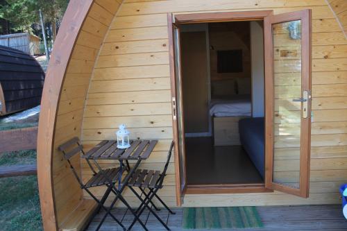 a sauna with a table and two chairs on a deck at Parque Biologico de Vinhais in Vinhais