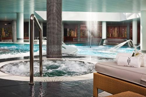 a swimming pool with a fountain in a hotel at Meliá Sol y Nieve in Sierra Nevada