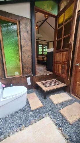a bathroom with a bath tub and a window at Tee Bungalow in the jungle in Ao Nang 