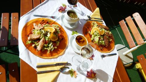 a table with two plates of food on it at Landhotel SONNENHOF MotorradKrauk in Ulrichsberg