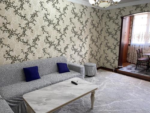 a living room with a couch and a table at Three rooms Apartment with all facilities in Tashkent