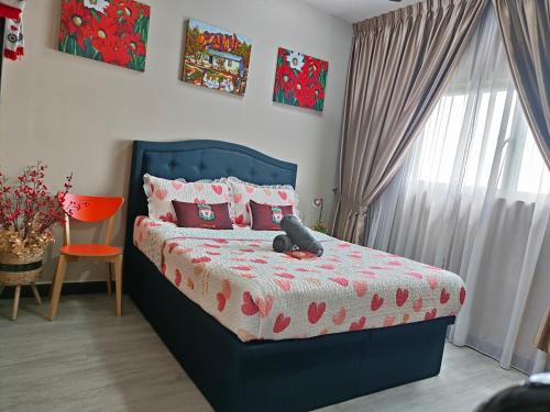 a bedroom with a bed with a teddy bear on it at YNWA Shankly Stay, Near KLIA in Sepang