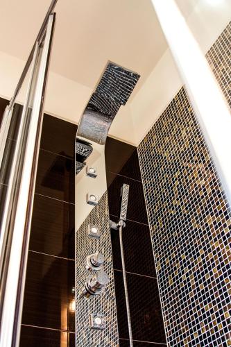 a bathroom with a shower with a tie in it at Quinta de Padreiro in Arcos de Valdevez