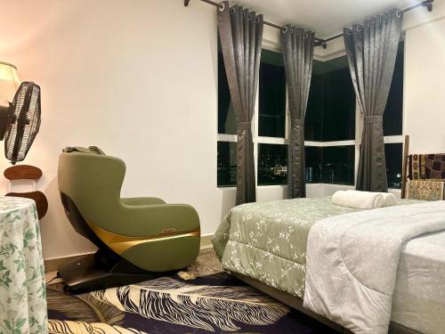 a bedroom with a green chair next to a bed and a window at Z&A CozyHome -Homestay in Seksyen 13, Shah Alam, MSU, AEON Mall in Shah Alam