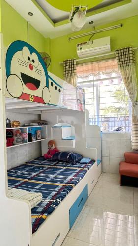 a bedroom with a bunk bed with a mickey mouse mural at HOMESTAY Hoàng GIa in Ấp Ông Tú