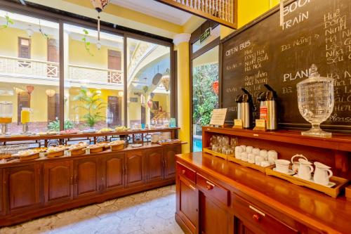 a restaurant with a counter with a bunch of food at Thanh Van 1 Hotel in Hoi An