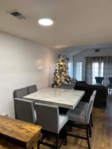 a dining room with a table and a christmas tree at Pipo’s perfect place in Jersey City