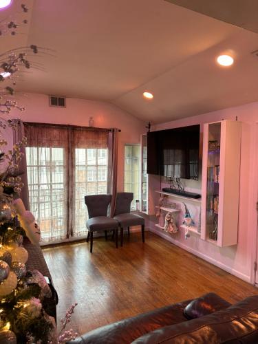 a living room with two chairs and a christmas tree at Pipo’s perfect place in Jersey City