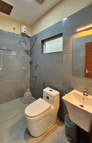 a bathroom with a toilet and a sink at Elephant Village Private Pool Villa in Munnar