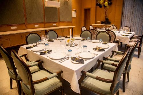 a dining room with a long table and chairs at Eden Wellness and Hospitality in Dehradun