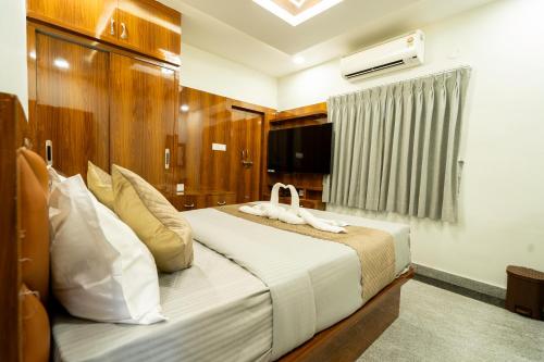 a bedroom with a large white bed in a room at SID Royale in Gachibowli
