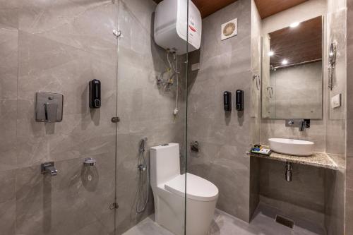 a bathroom with a toilet and a sink at Echor Himalayan Heights Luxe Manali in Manāli