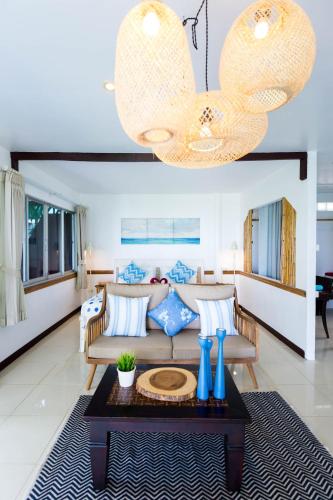 a living room with a couch and a table at the ocean resort samui in Lamai