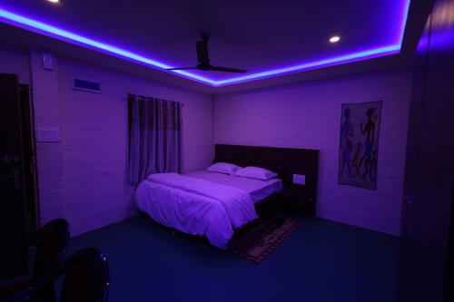 a purple room with a bed with a purple ceiling at Shriman Valley in Konārka