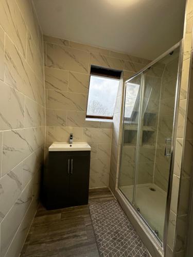 a bathroom with a sink and a shower at Grove Rooms 2 in London