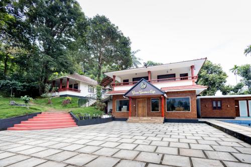 a building with a courtyard in front of it at Green Garden Wayanad Villas in Vayittiri