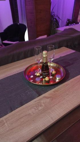 a tray with two glasses and a bottle on a table at Casa Villar in Alcalá del Júcar