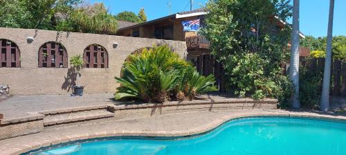 a swimming pool in front of a house at Haley's cabin in Tauranga