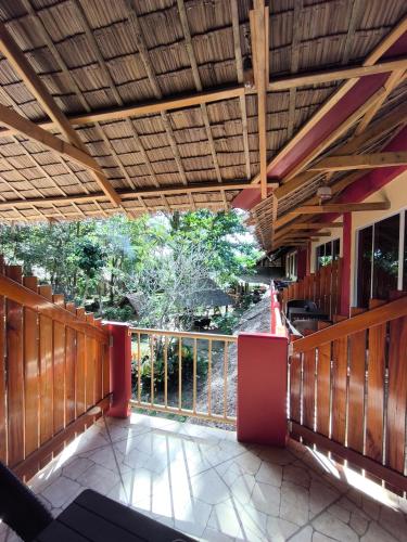 a porch with a wooden fence and a deck at Sulu Sunset Beach Resort in Nauhang