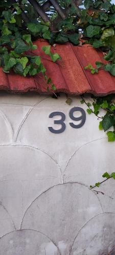 a sign with the number on the sidewalk at Haley's cabin in Tauranga