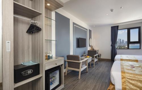 a hotel room with a bed and a fireplace at Ruby Hotel in Nha Trang
