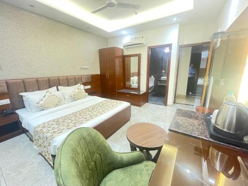 a hotel room with a bed and a table and chairs at Hotel The Saffron Park in Panchkula