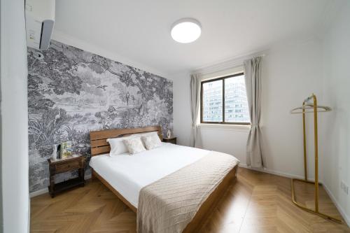 a bedroom with a bed and a wall mural at Tonight Homestay West Nanjing Road Branch Shanghai in Shanghai