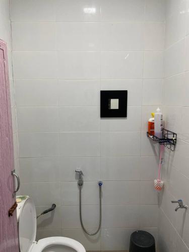 a bathroom with a toilet and a shower at D'Padang KB Homestay in Kuala Berang