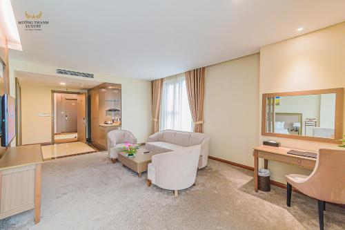 a living room with a couch and a table at Muong Thanh Luxury Ca Mau Hotel in Cà Mau