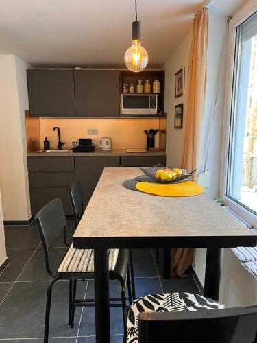 a kitchen with a table with a bowl of fruit on it at Stellar Mátra in Mátraszentimre