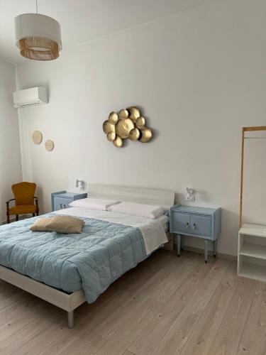 a bedroom with a bed and two blue tables at Avia Room in Pachino