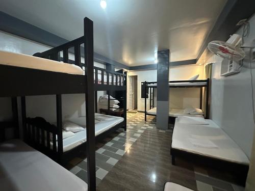 a room with three bunk beds in a room at Baler Reese Place in Baler