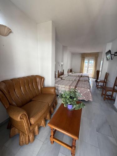 a living room with a couch and a bed at Hotel Mirasol in Órgiva