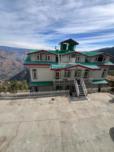 a large building on the top of a mountain at Perfecto Stays in Mashobra