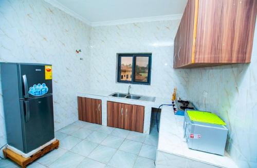 a kitchen with a sink and a refrigerator at MIKES's AB & B in Kwabenya