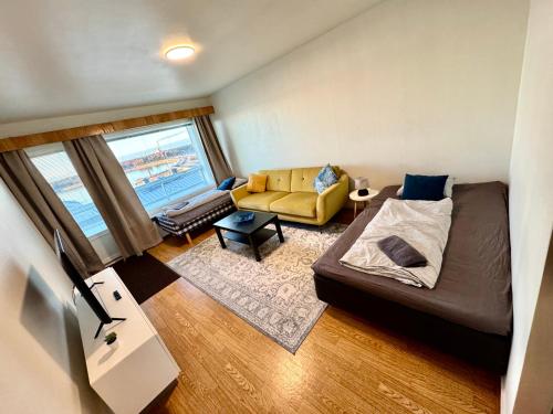 een woonkamer met een bed en een bank bij DP Apartments Vaasa III in Vaasa