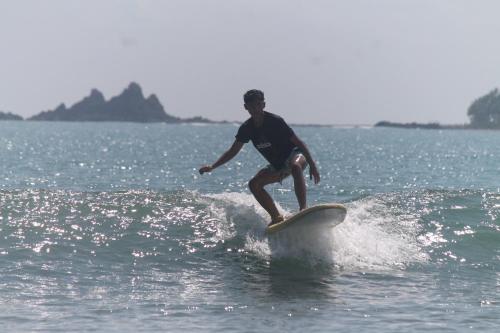 a man riding a wave on a surfboard in the ocean at Baler Reese Place in Baler