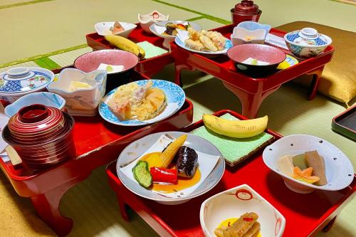 a table with different plates of food on it at 高野山 宿坊 大円院 -Koyasan Shukubo Daienin- in Koyasan