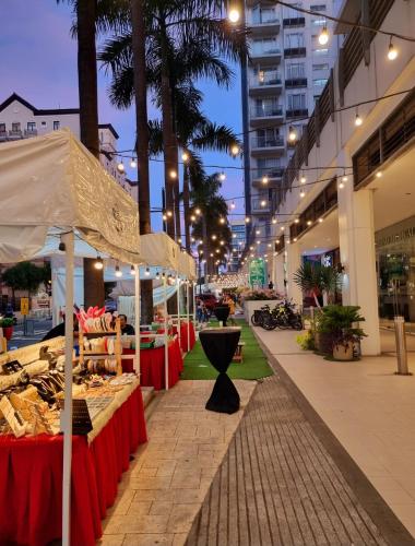 a market with a table of food on a street at Condo Airport NAIA Terminal-3 One Palm Tree Villas in Manila