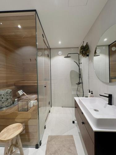 a bathroom with a sink and a shower at Hidden Gem with Private Sauna, In City Center in Helsinki