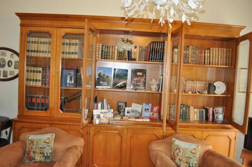 a large wooden book shelf filled with books at Villa L'Aurora in Pescara