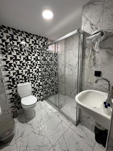 a bathroom with a toilet and a shower and a sink at Medi Otel in Samsun