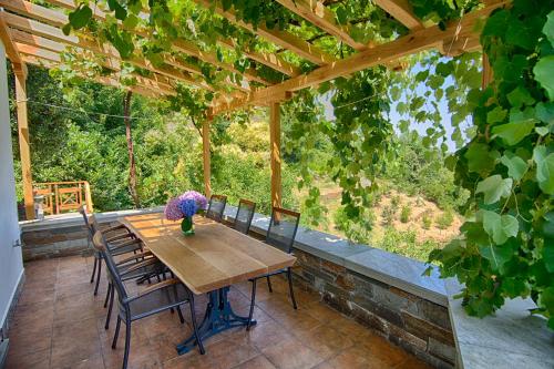 a wooden table and chairs on a patio at Mila House in Mouresi