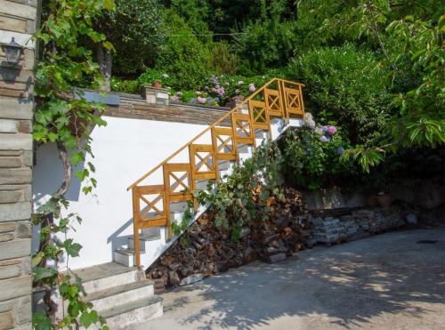 a wooden staircase with flowers on a wall at Mila House in Mouresi