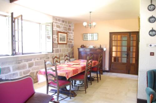 une salle à manger avec une table et des chaises dans l'établissement Gîte familial à la campagne, à Brignac-la-Plaine