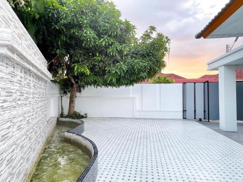 a koi pond in the courtyard of a house at 4BR Home with large beds near mall & beaches in Ban Tha Rua